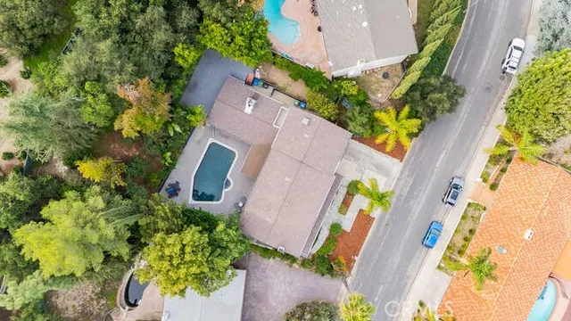 an aerial view of a house with a yard and garden