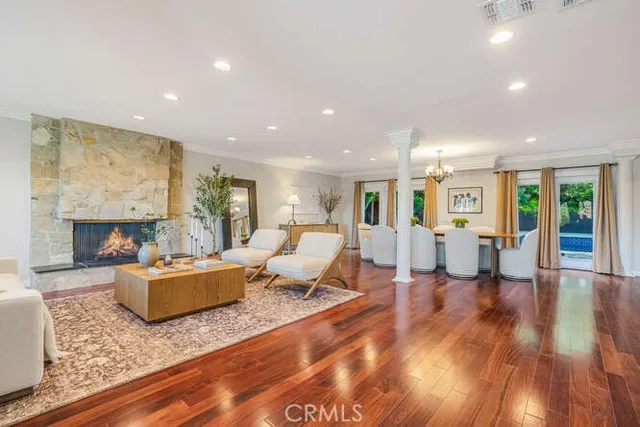 a living room with fireplace furniture and a wooden floor