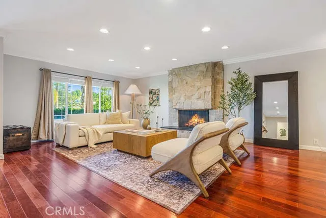a living room with fireplace furniture and a wooden floor