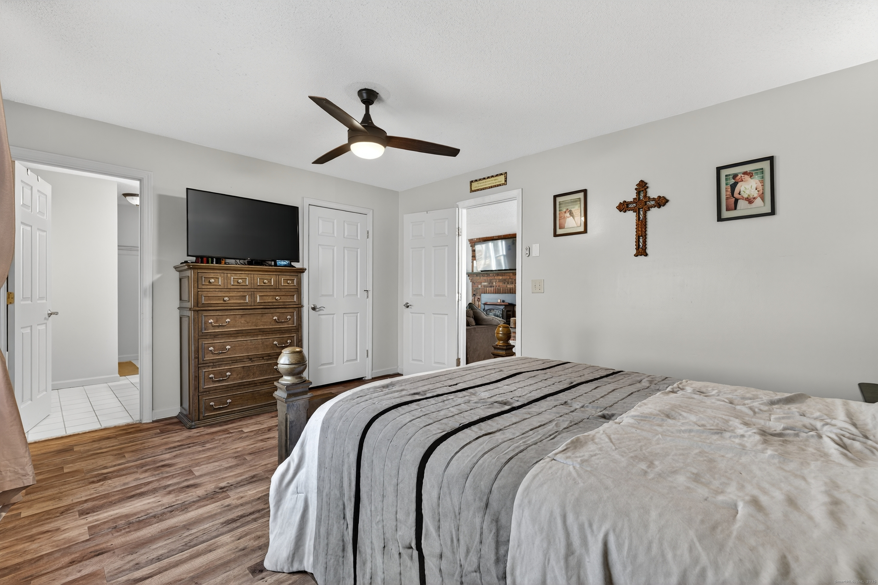 116 Spicer Hill Road Ledyard, CT 06339 - Photo 19 of 29 a bedroom with a bed and a flat screen tv