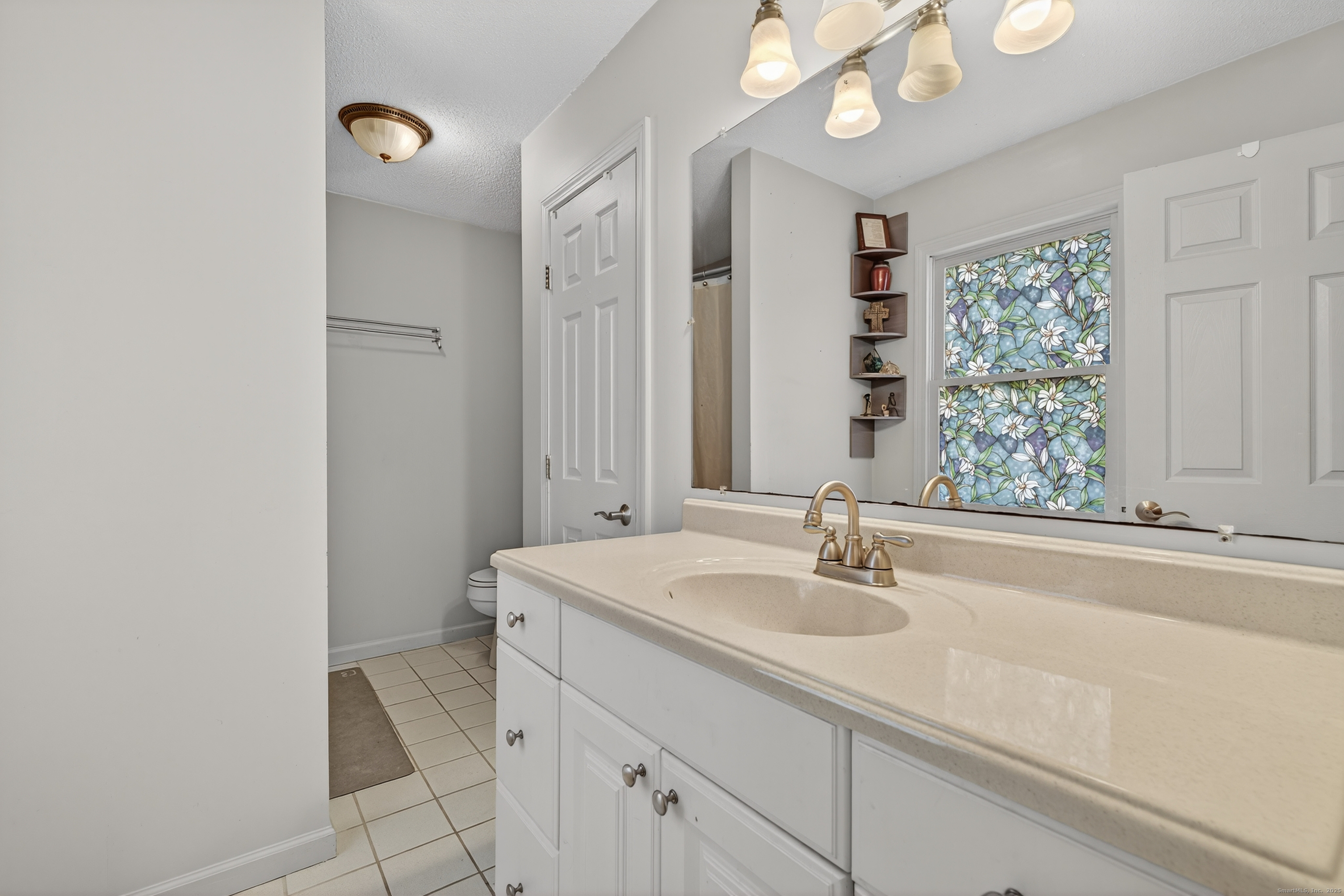 116 Spicer Hill Road Ledyard, CT 06339 - Photo 20 of 29 a bathroom with a sink and a mirror