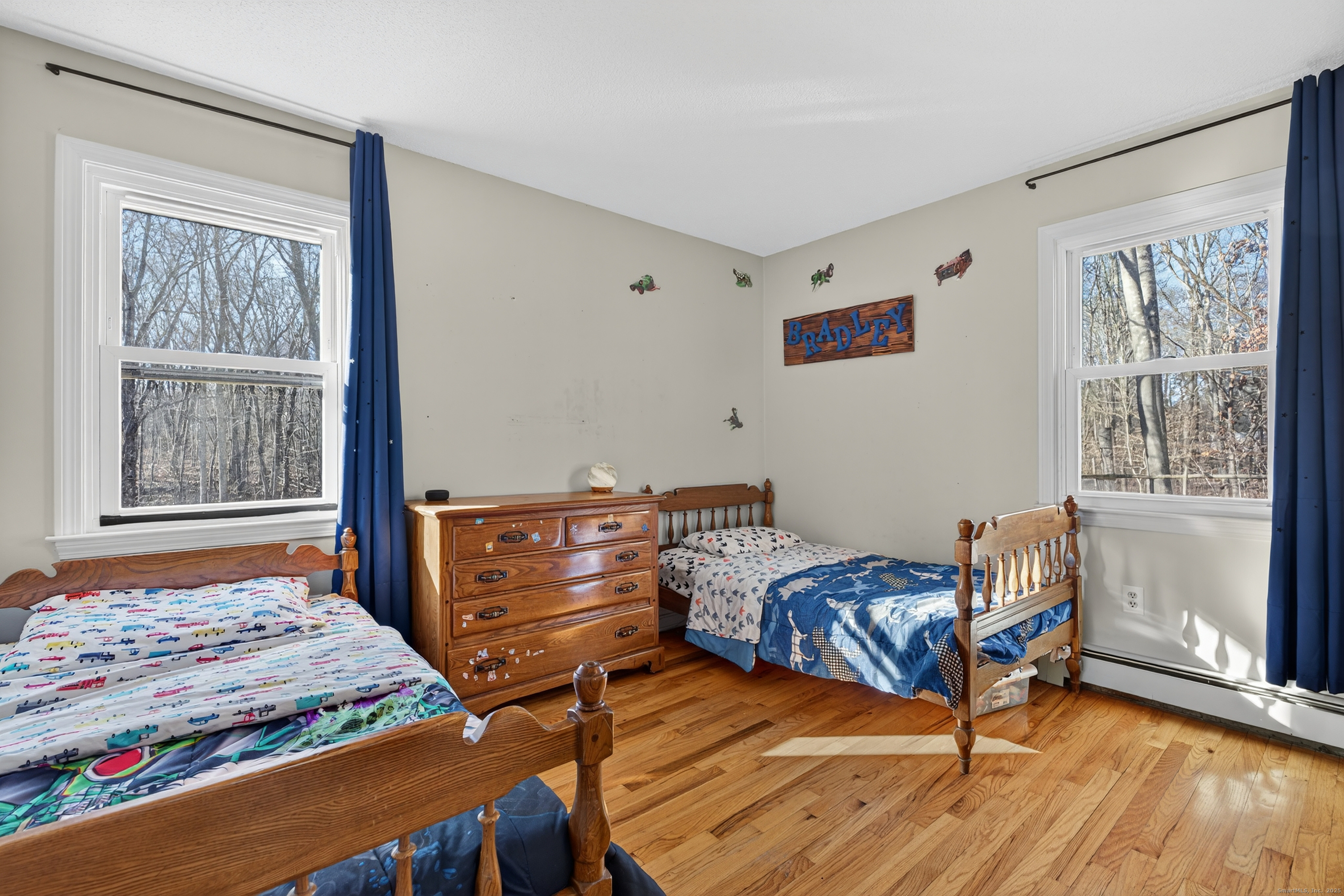 116 Spicer Hill Road Ledyard, CT 06339 - Photo 24 of 29 a bedroom with a bed and wooden floor
