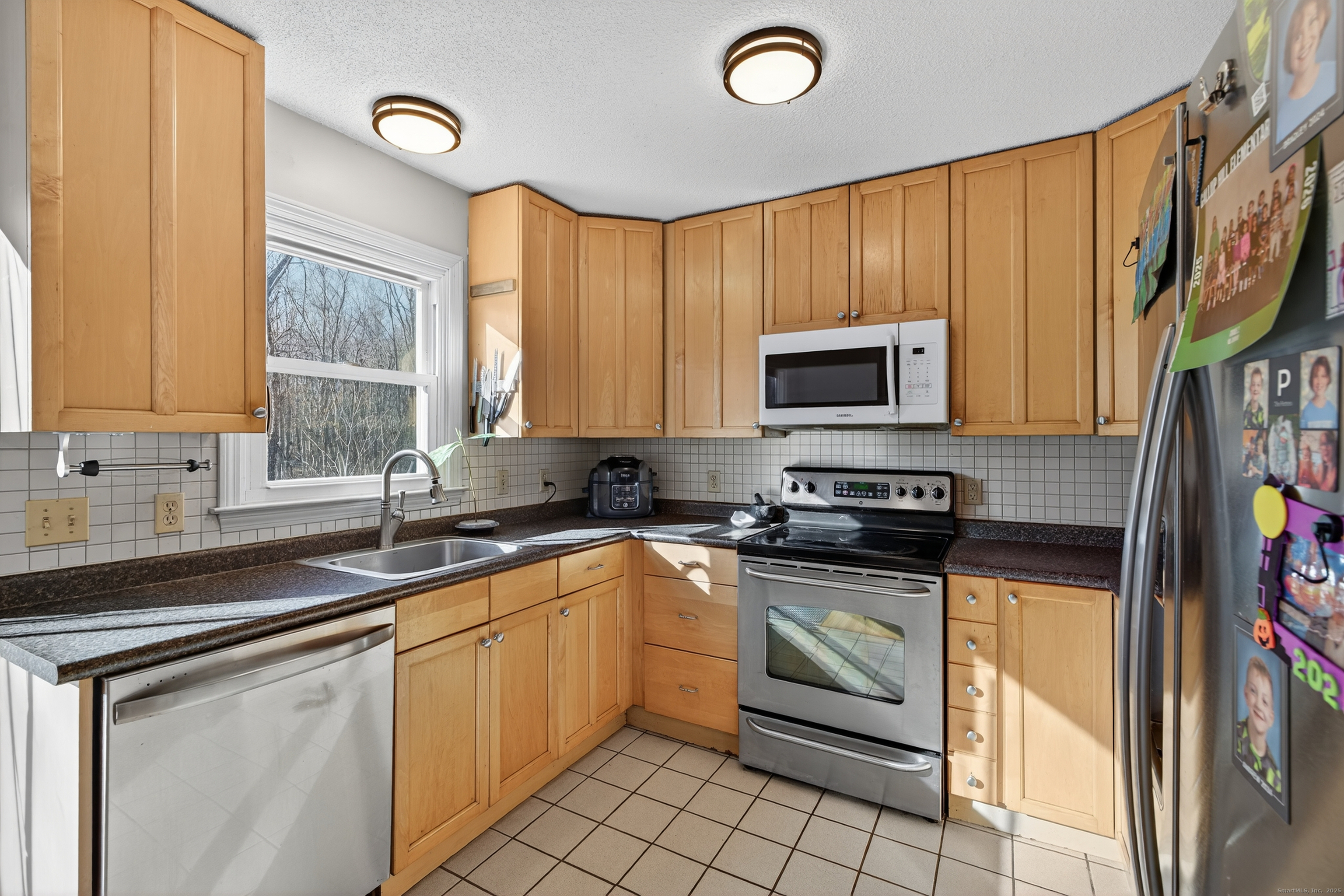116 Spicer Hill Road Ledyard, CT 06339 - Photo 10 of 29 a kitchen with stainless steel appliances granite countertop a stove sink microwave and cabinets