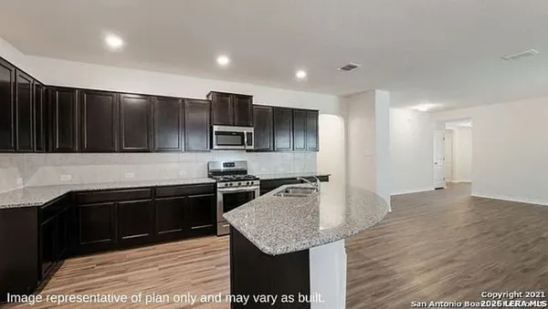 a kitchen with stainless steel appliances granite countertop a sink stove and microwave