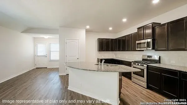 a kitchen with stainless steel appliances granite countertop a sink stove microwave and cabinets
