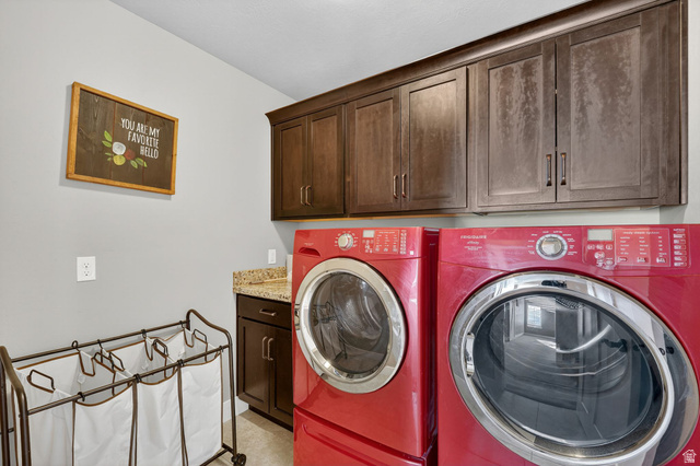 14714 South Bright Wood Road Herriman, UT 84096 - Photo 31 of 41 Laundry room featuring cabinet space and washer and clothes dryer