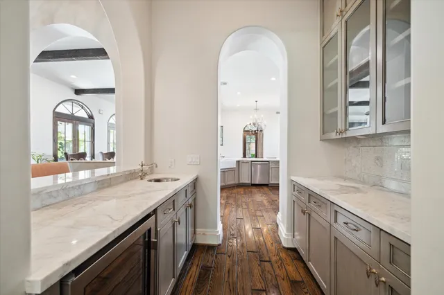 a spacious bathroom with a granite countertop sink a mirror and a shower