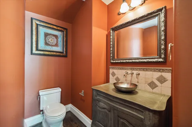 a bathroom with a toilet a sink and mirror