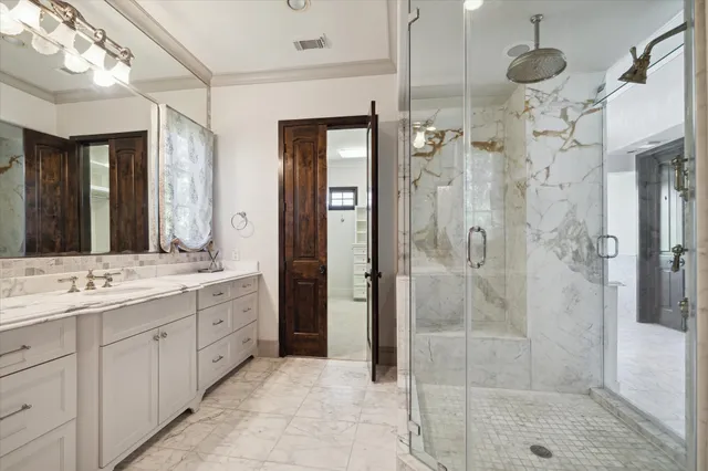 a bathroom with a granite countertop sink mirror and shower