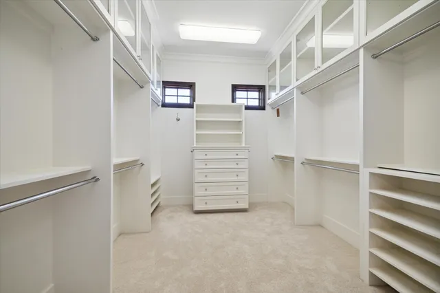 a view of walk in closet with empty racks