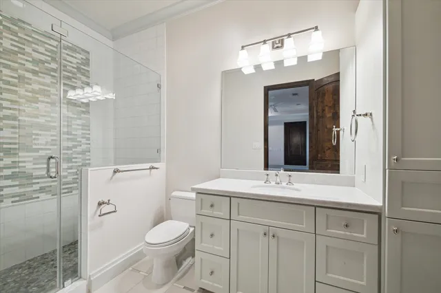 a bathroom with a sink vanity granite toilet and a mirror