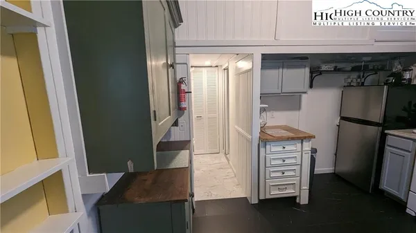 a kitchen with a refrigerator and a stove