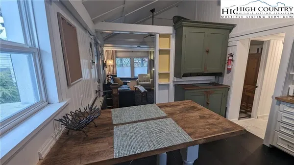 a view of kitchen island with furniture and refrigerator