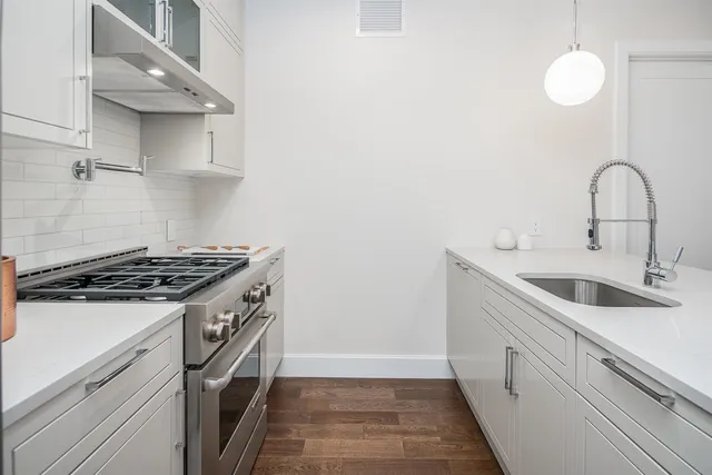 a kitchen with a sink and cabinets