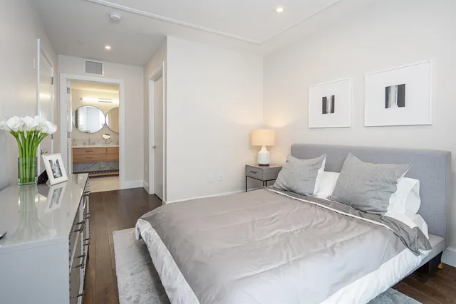 a large white bed in a white room