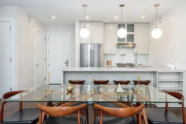 a view of kitchen with granite countertop cabinets table and chairs