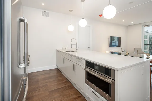 a kitchen with a sink and a refrigerator