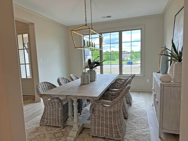 a dining room with furniture and window