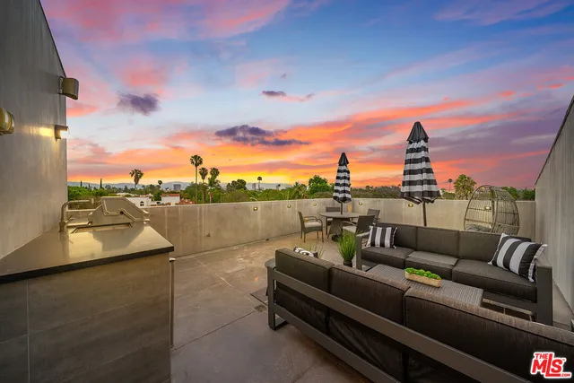 a view of a terrace with couches and sky view
