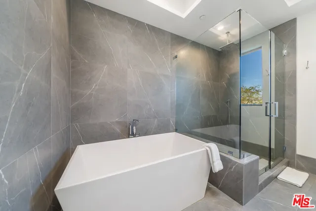 a bathroom with a bathtub and a shower