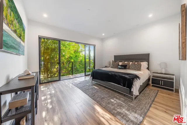 a bedroom with a large bed and a large window