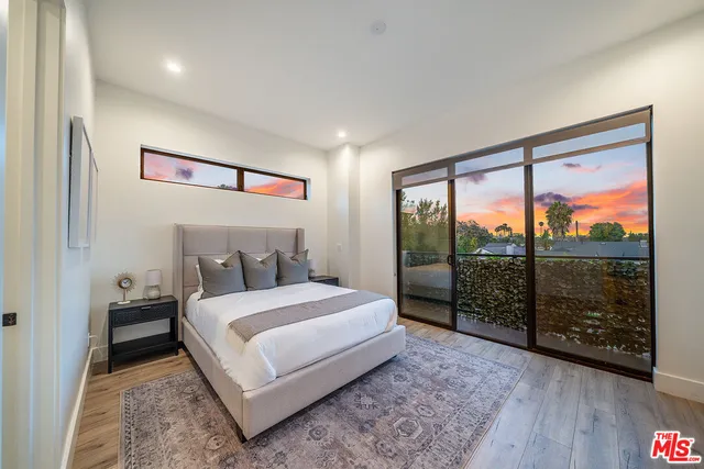 a bedroom with a large bed and a large window