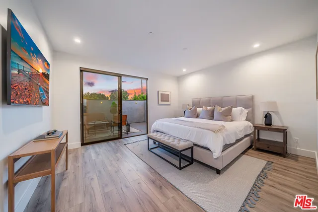 a bedroom with a bed and a mirror