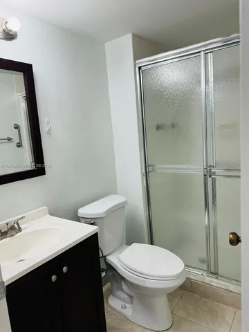 a bathroom with a sink vanity mirror and toilet