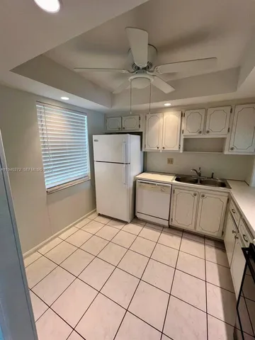 a stove top oven sitting inside of a kitchen