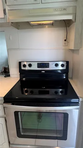 a kitchen with white cabinets and a sink
