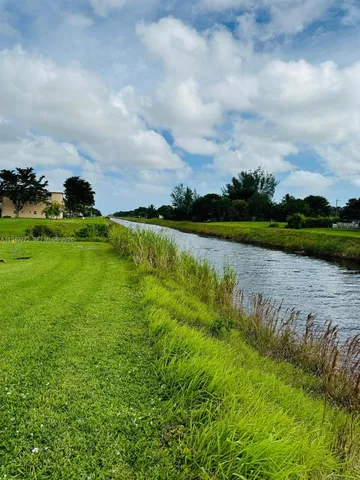 a view of a lake with a houses in the back