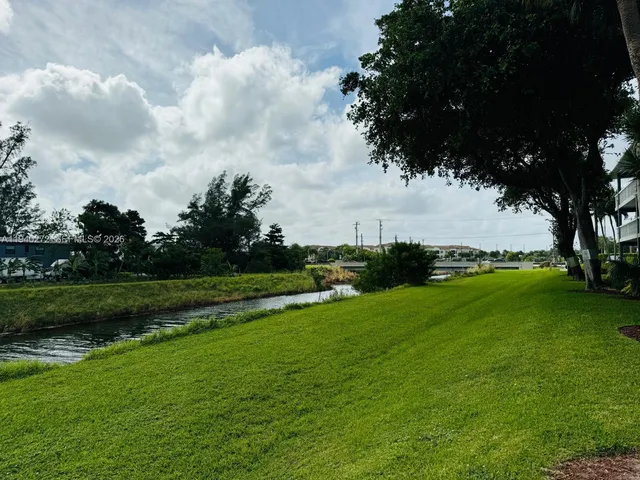 a view of a lake with houses in the back