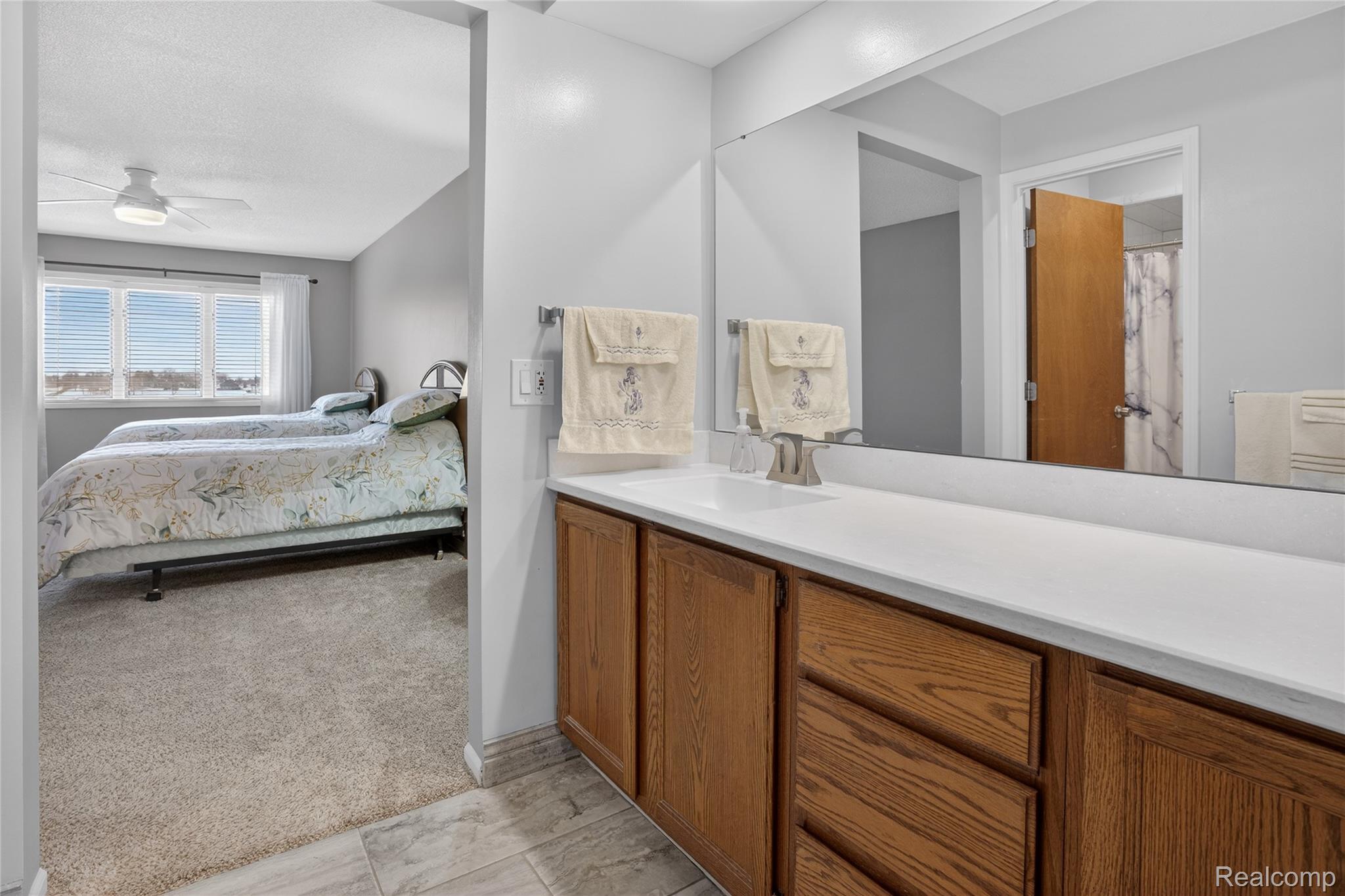 1715 River Road, Unit 77 St. Clair, MI 48079 - Photo 45 of 59 Bedroom with a ceiling fan and light colored carpet