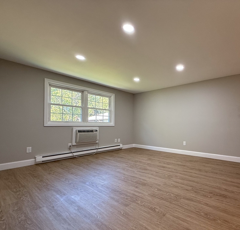 96 Richardson Road, Unit A22 Chelmsford, MA 01863 - Photo 3 of 22 an empty room with wooden floor and windows