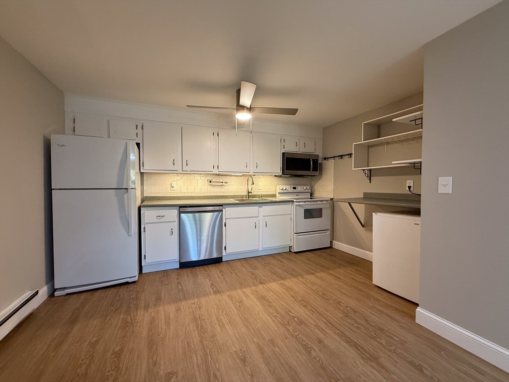 96 Richardson Road, Unit A22 Chelmsford, MA 01863 - Photo 5 of 22 a kitchen with stainless steel appliances a refrigerator sink and cabinets