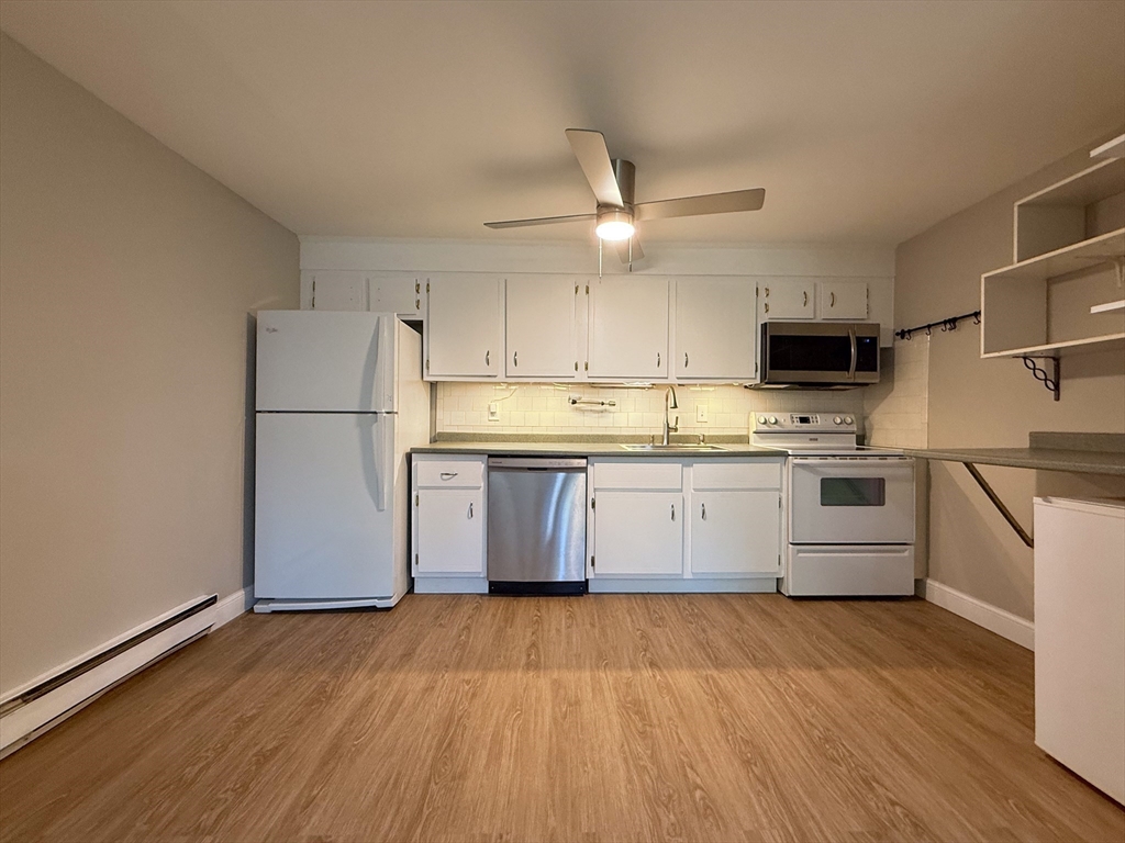 96 Richardson Road, Unit A22 Chelmsford, MA 01863 - Photo 6 of 22 a kitchen with a white cabinets and stainless steel appliances
