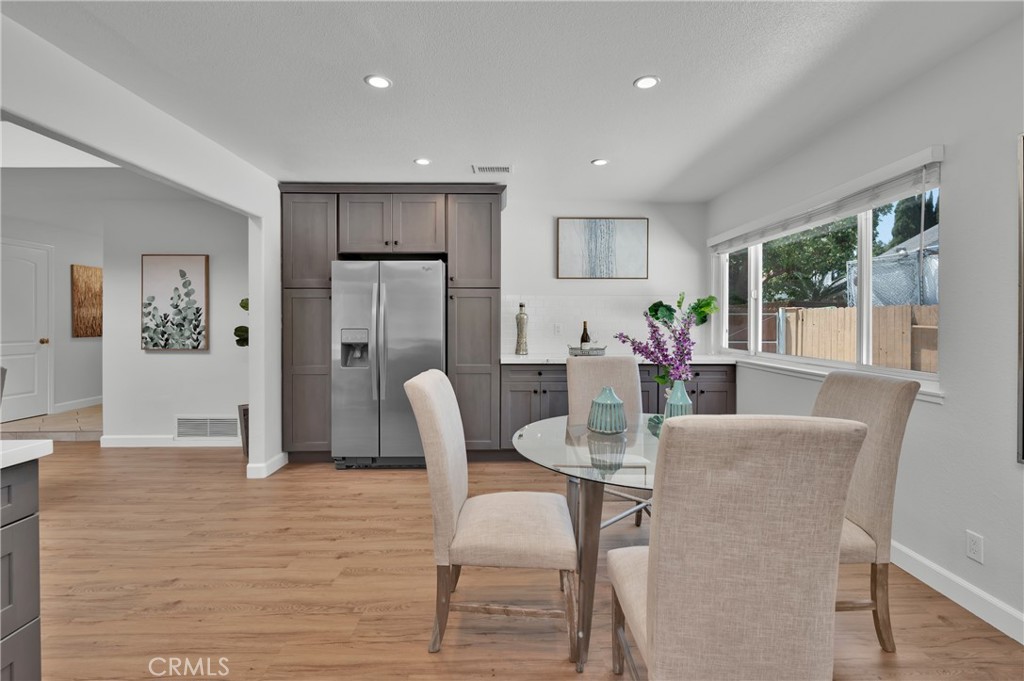 4829 East Kenyon Place Orange, CA 92869 - Photo 15 of 42 a view of a dining room with furniture and wooden floor