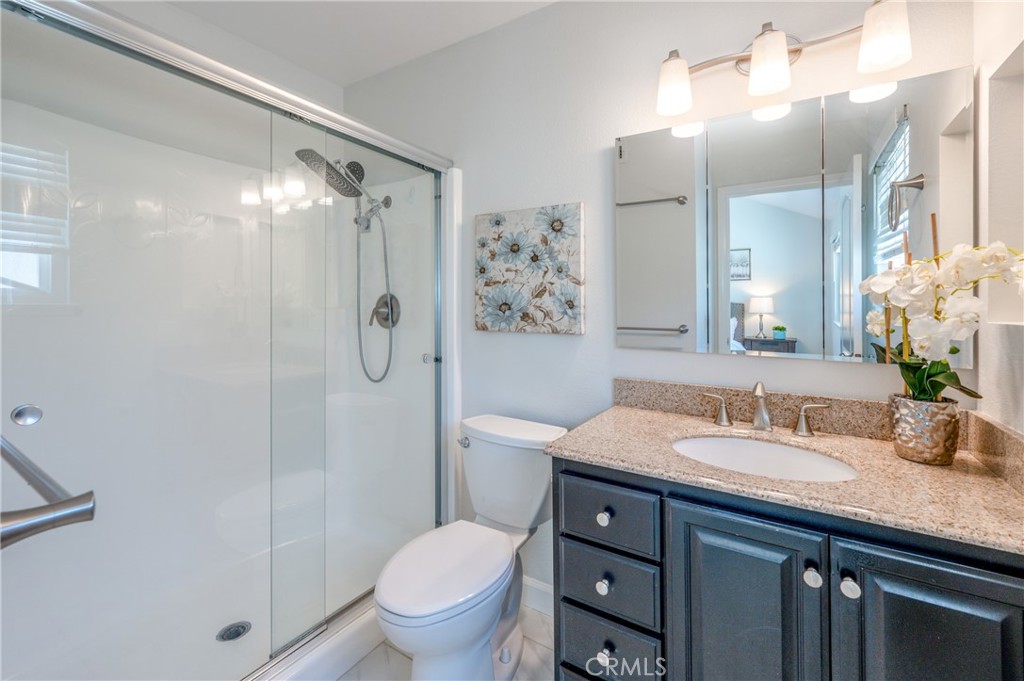 4829 East Kenyon Place Orange, CA 92869 - Photo 20 of 42 a bathroom with a granite countertop sink toilet and shower