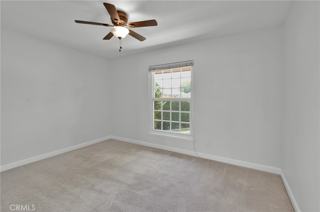 4829 East Kenyon Place Orange, CA 92869 - Photo 23 of 42 an empty room with a window and a fan