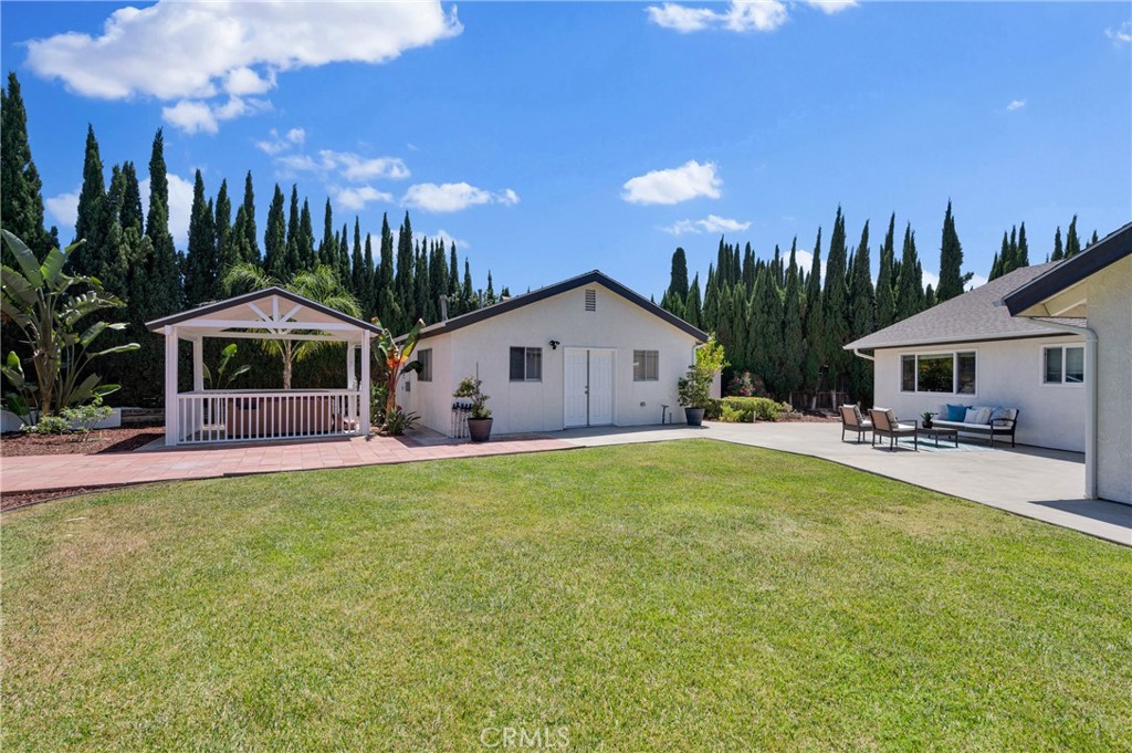 4829 East Kenyon Place Orange, CA 92869 - Photo 29 of 42 a front view of house with yard and outdoor seating