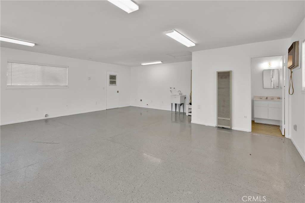 4829 East Kenyon Place Orange, CA 92869 - Photo 30 of 42 an empty room with a cabinet and mirrors