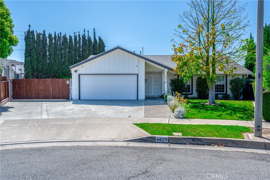 4829 East Kenyon Place Orange, CA 92869 - Photo 3 of 42 a house with a yard and a large parking space