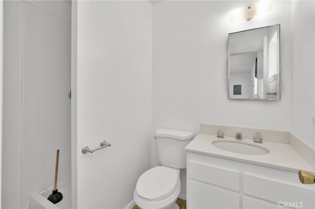 4829 East Kenyon Place Orange, CA 92869 - Photo 32 of 42 a bathroom with a sink toilet and mirror