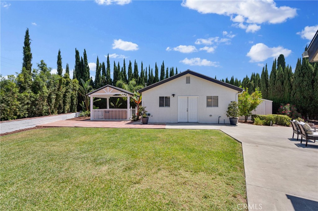 4829 East Kenyon Place Orange, CA 92869 - Photo 33 of 42 a swimming pool with outdoor seating and yard