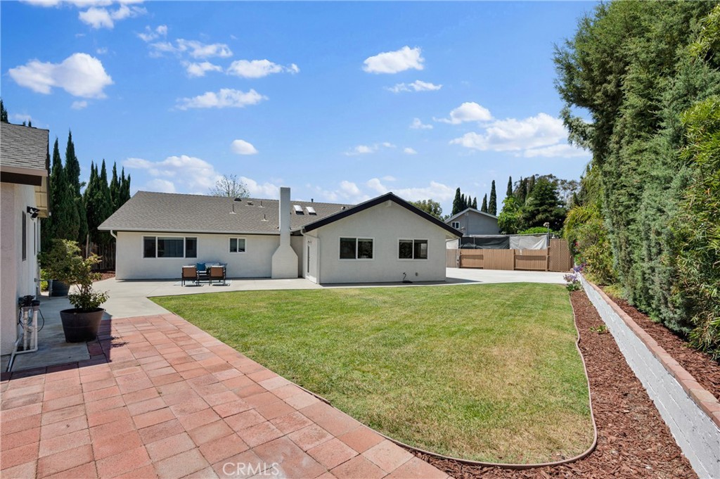 4829 East Kenyon Place Orange, CA 92869 - Photo 36 of 42 a view of a house with a backyard porch and a garden