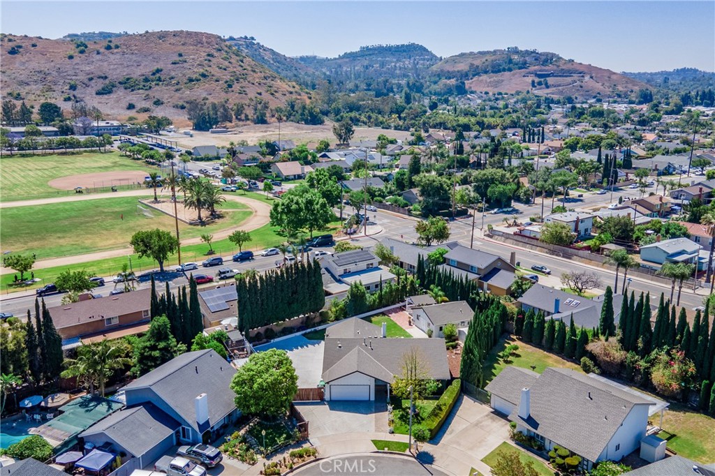 4829 East Kenyon Place Orange, CA 92869 - Photo 42 of 42 an aerial view of a city with lots of residential buildings and mountain view in back