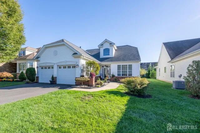 a front view of a house with garden and porch