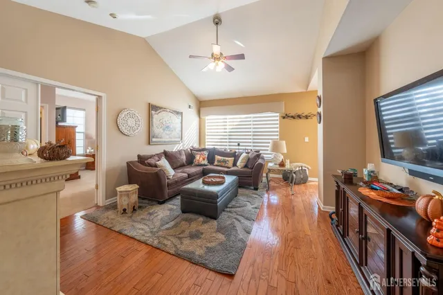 a living room with furniture fireplace and flat screen tv