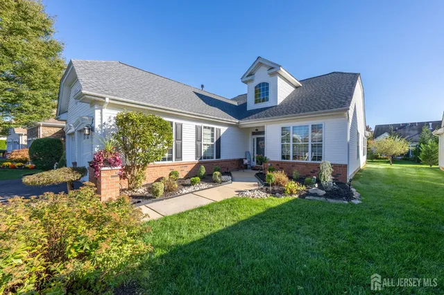 a view of a house with backyard and sitting area