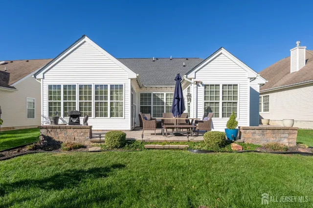 a front view of house with yard and outdoor seating